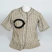 Worn baseball jersey with letter C on the left side.